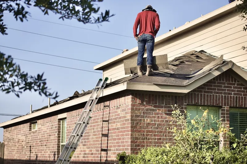 Professional roofer working on a residential roof in French Hill